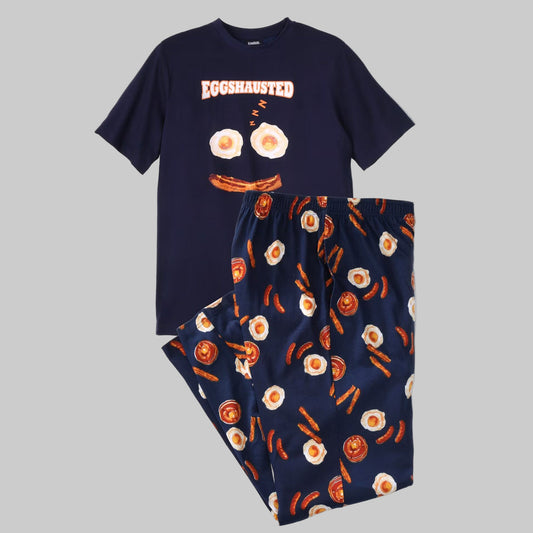 Plus-size man wearing a fun bacon and egg printed cotton pajama set featuring a crewneck T-shirt and relaxed-fit pants with side pockets.