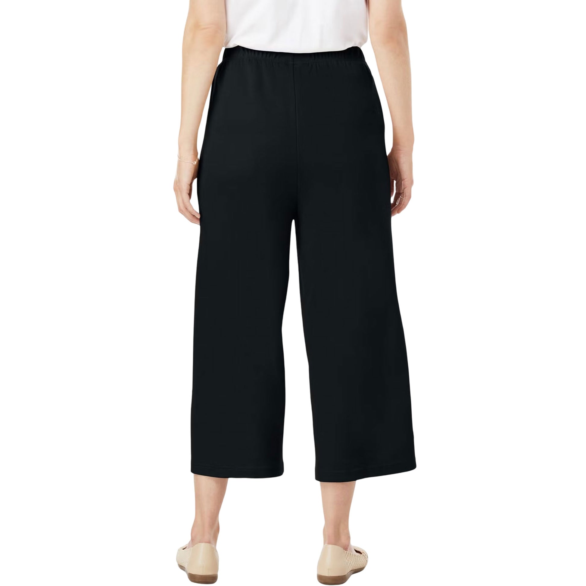 Black knit culotte capri pants on hanger showing pleat detail and drape
