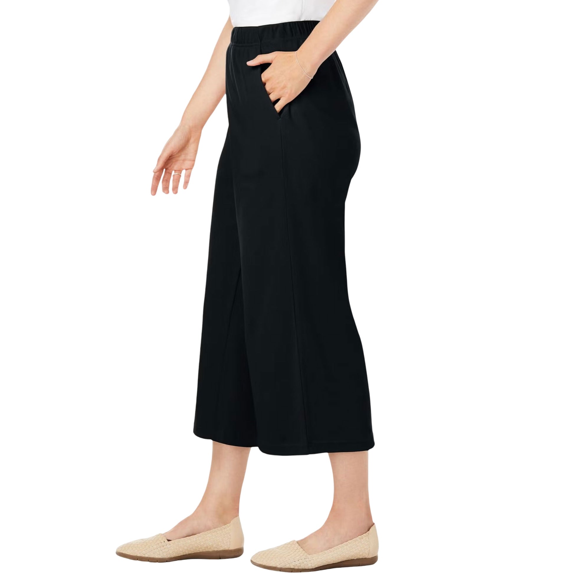 Black knit culotte capri pants on hanger showing pleat detail and drape