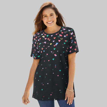 Women’s black graphic tee with colorful falling heart print, short sleeves, and relaxed fit, displayed on a clean studio background.
