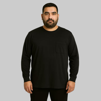 Plus-size Pakistani male model wearing black long-sleeve crewneck pocket T-shirt on a clean studio background.