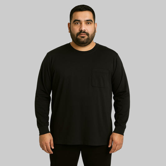 Plus-size Pakistani male model wearing black long-sleeve crewneck pocket T-shirt on a clean studio background.