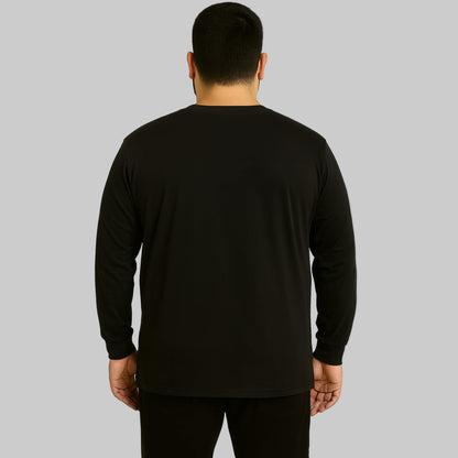 Plus-size Pakistani male model wearing black long-sleeve crewneck pocket T-shirt on a clean studio background.