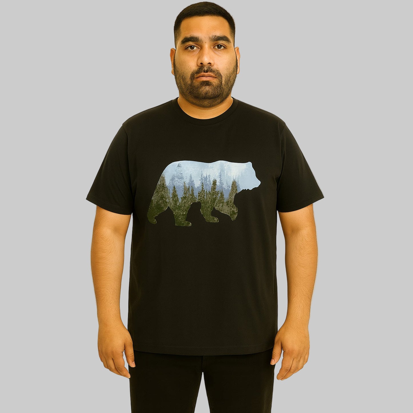 Plus-size Pakistani male model wearing black nature graphic T-shirt with relaxed fit on a clean studio background.