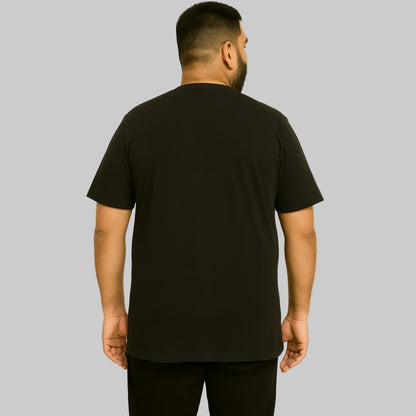 Plus-size Pakistani male model wearing black nature graphic T-shirt with relaxed fit on a clean studio background.
