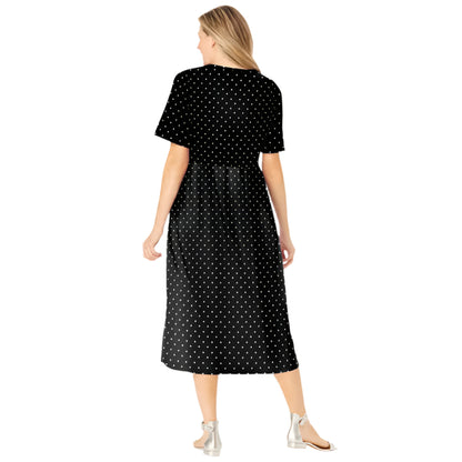 Woman wearing black polka dot button-front dress with gathered waist and flowing skirt