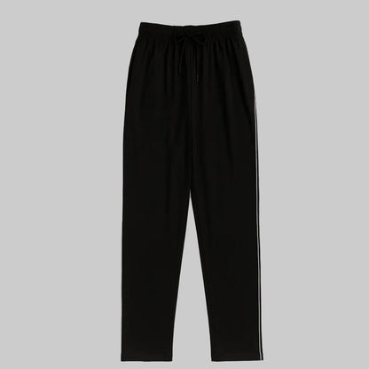 Black plus-size jogger trousers with subtle side stripe, worn by a 2XL Pakistani male model on a clean white background.