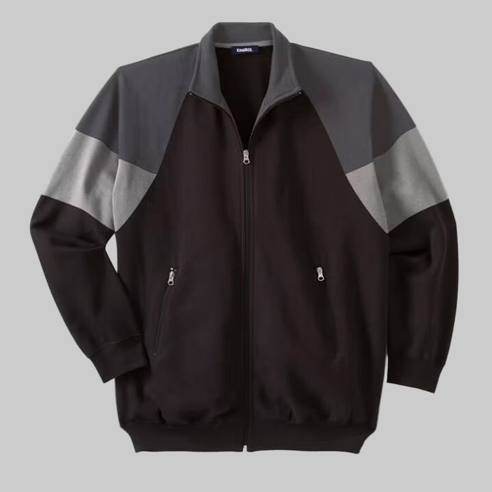 Black wicking color block full zip track jacket with ribbed cuffs, hem, and front zip pockets, made from soft moisture-wicking cotton-poly fabric.