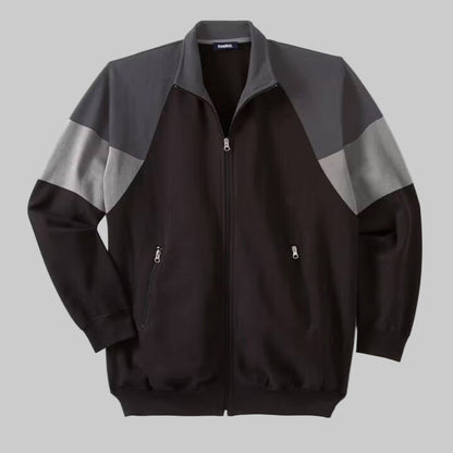 Black wicking color block full zip track jacket with ribbed cuffs, hem, and front zip pockets, made from soft moisture-wicking cotton-poly fabric.