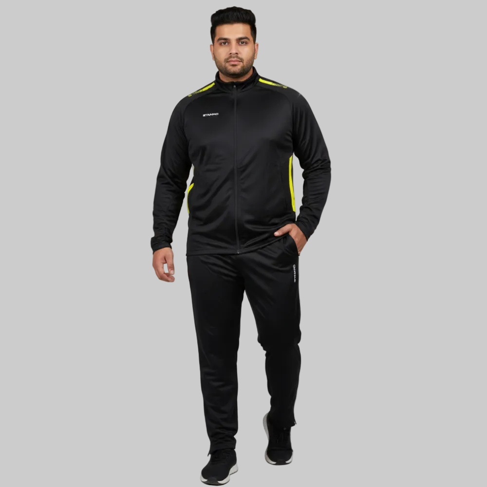 Men’s black activewear tracksuit with yellow accents, full zip jacket and slim fit trousers on a gray background