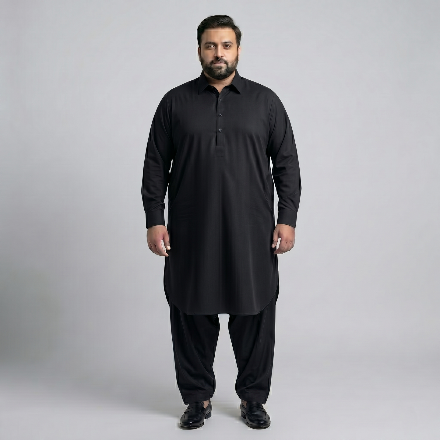 Man wearing a black traditional outfit on a gray background