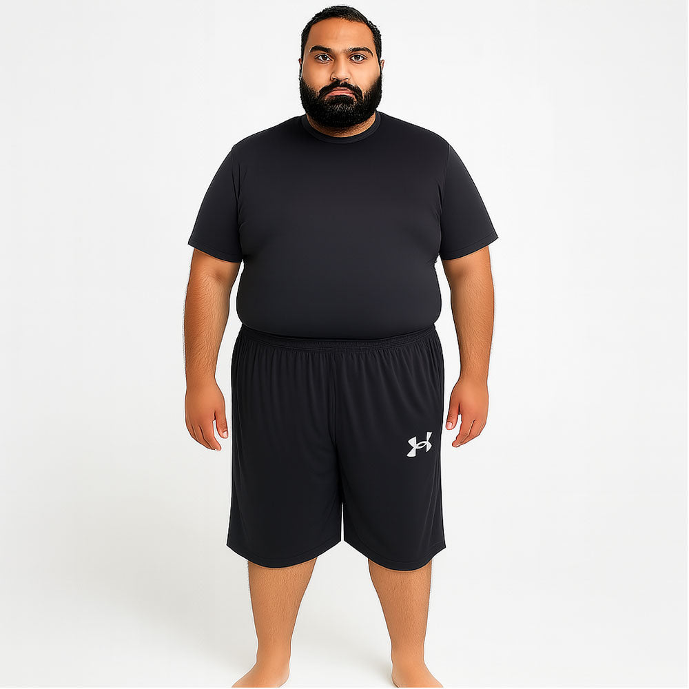 Pakistani plus-size male model wearing Black Dry-Fit Three Quarter Shorts – front view, relaxed fit, studio lighting