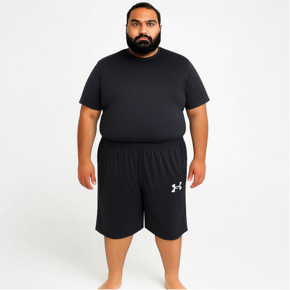 Pakistani plus-size male model wearing Black Dry-Fit Three Quarter Shorts – front view, relaxed fit, studio lighting
