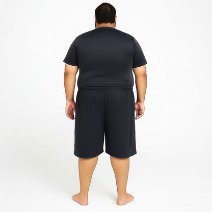 Pakistani plus-size male model wearing Black Dry-Fit Three Quarter Shorts – front view, relaxed fit, studio lighting