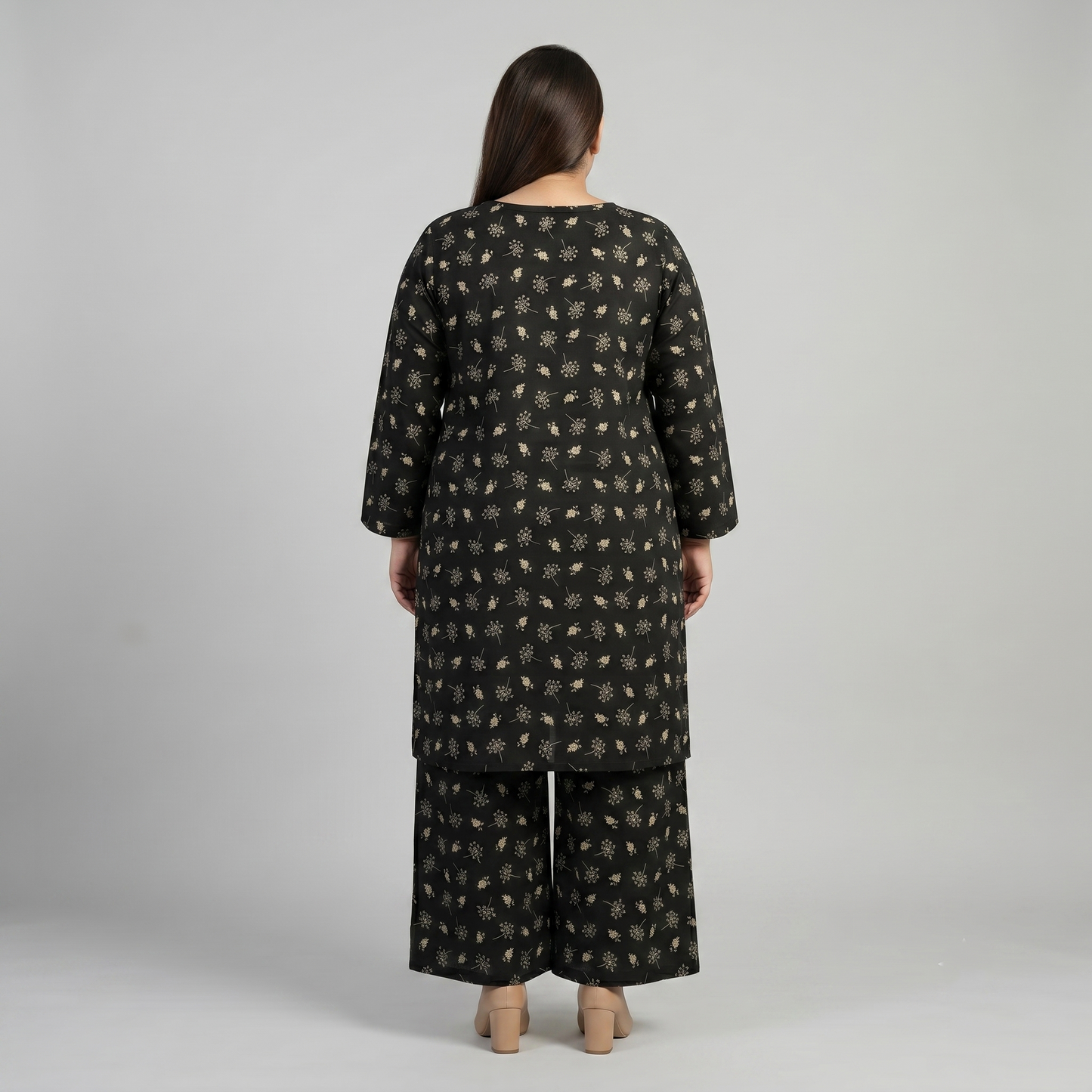 Woman wearing a patterned outfit on a plain background