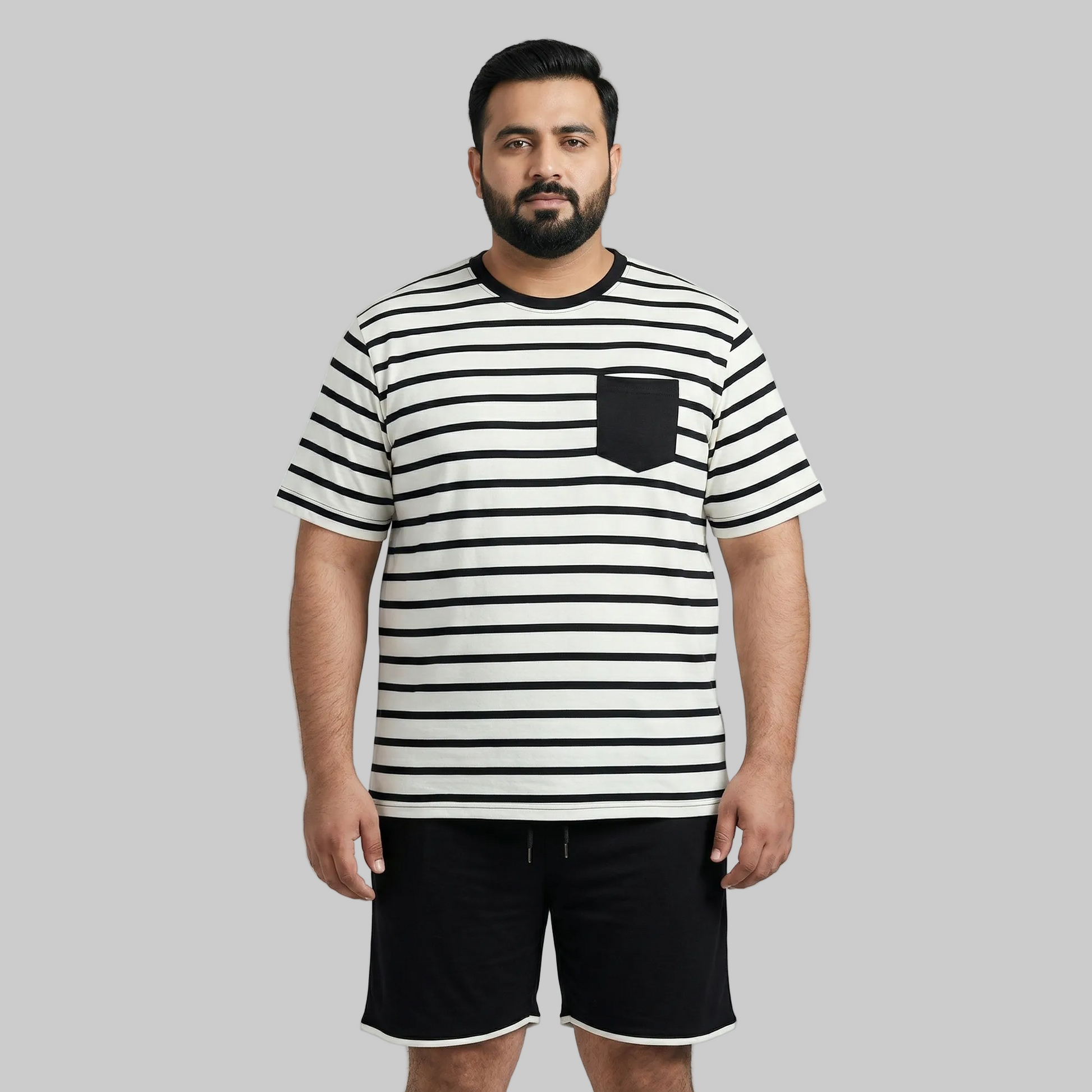 Man wearing a black and white striped t-shirt with a pocket on a gray background