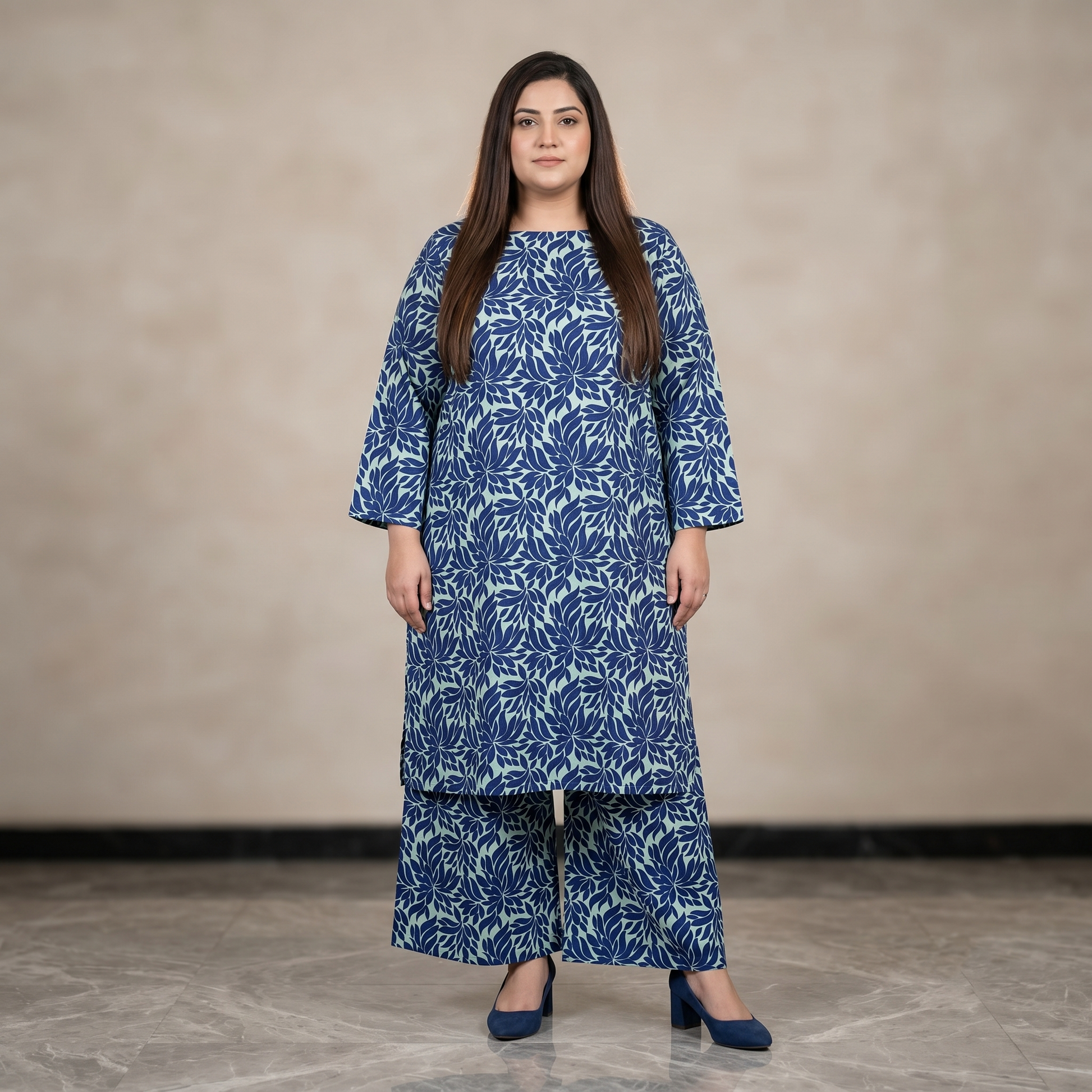Woman wearing a blue floral patterned outfit against a beige background