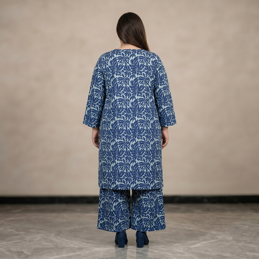 Woman wearing a blue floral patterned outfit against a beige background