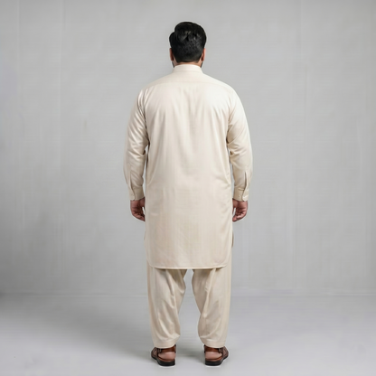 Man wearing a beige kurta set against a plain background