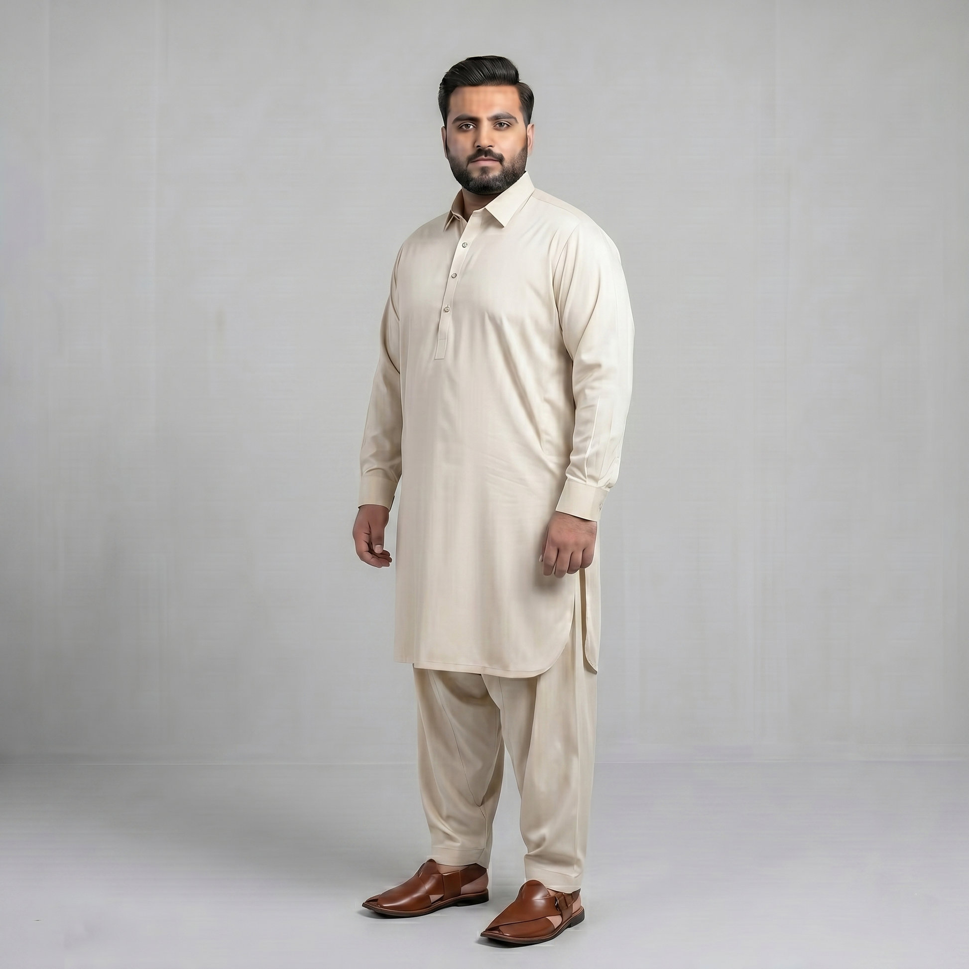 Man wearing a beige kurta with brown shoes on a gray background