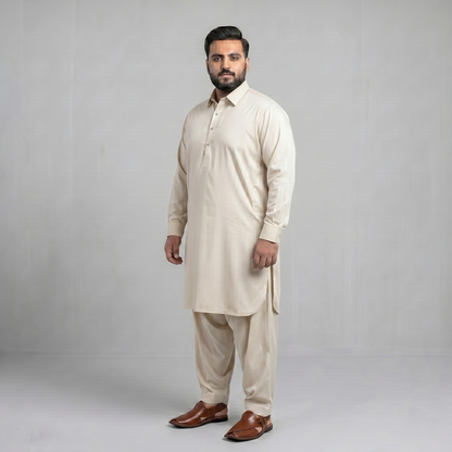 Man wearing a beige kurta with brown shoes on a gray background