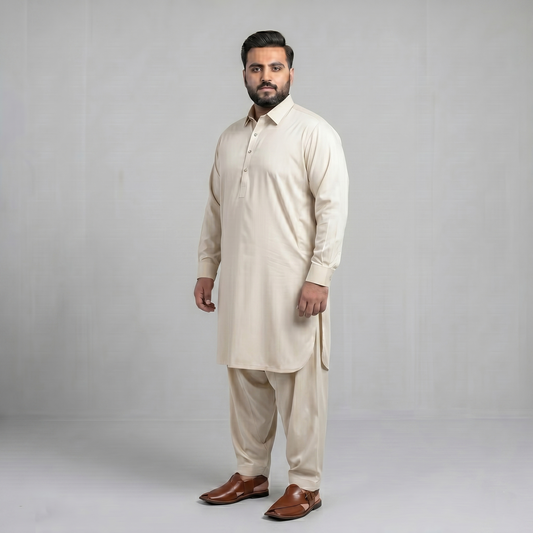 Man wearing a beige kurta with brown shoes on a gray background