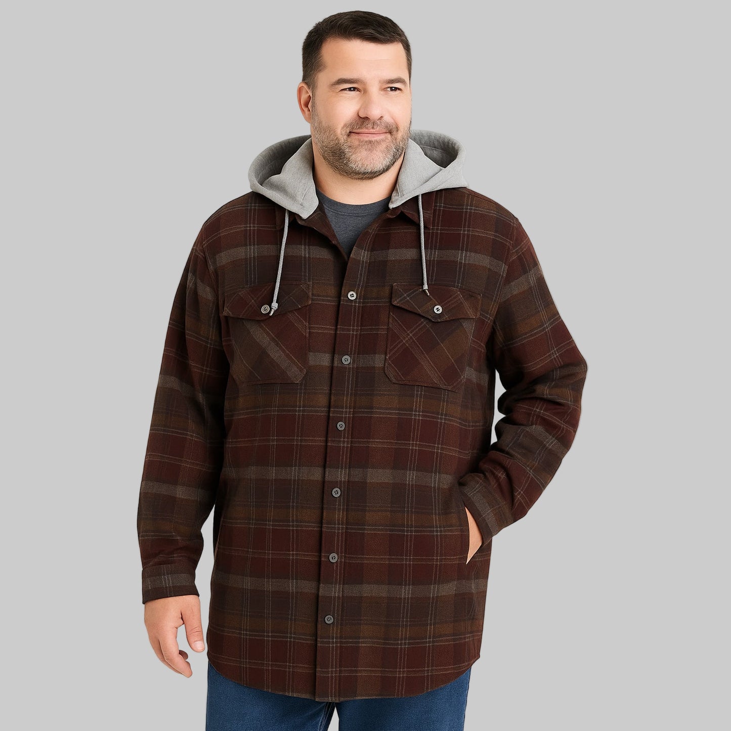 Brown plaid flannel shirt jacket with removable grey hood, button front, and flap chest pockets, displayed on a neutral background.