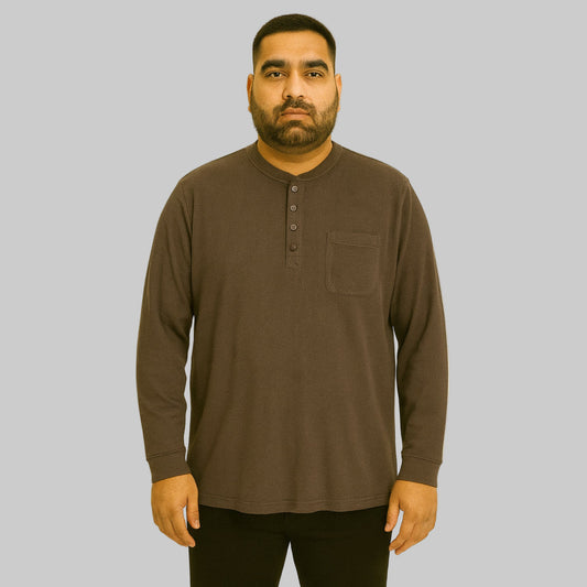Plus-size Pakistani male model wearing brown waffle-knit thermal Henley tee on a studio background, long sleeves, relaxed fit.
