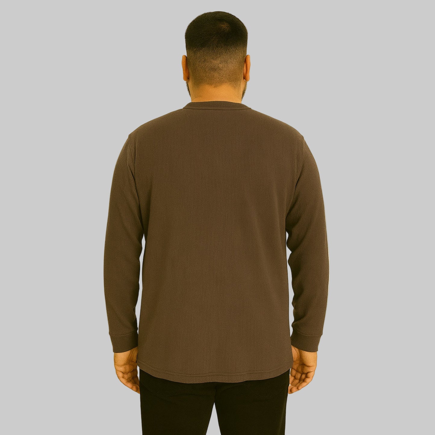Plus-size Pakistani male model wearing brown waffle-knit thermal Henley tee on a studio background, long sleeves, relaxed fit.