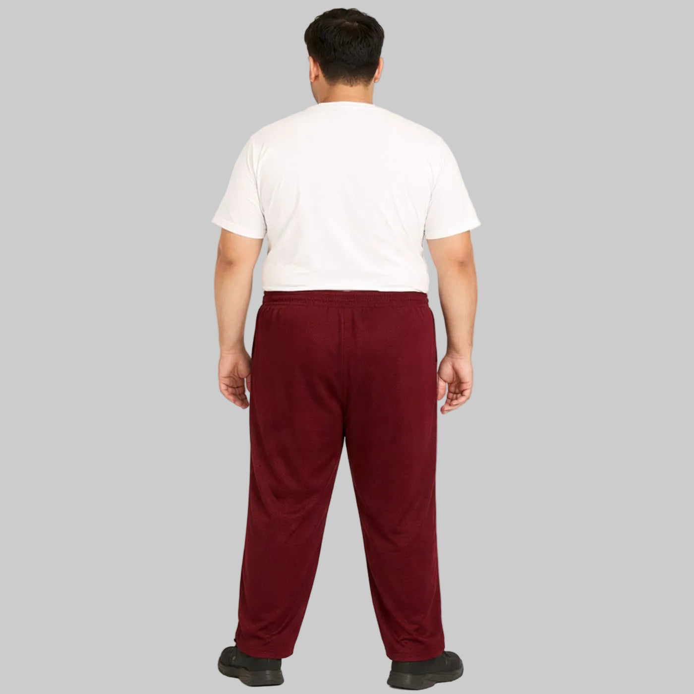 Burgundy mesh polyester plus size trouser worn by a male model, featuring breathable fabric and a comfortable relaxed fit