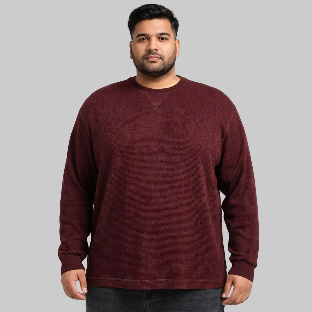 Pakistani male model wearing a burgundy waffle-knit thermal crewneck shirt in big size fit, front view on a light background.