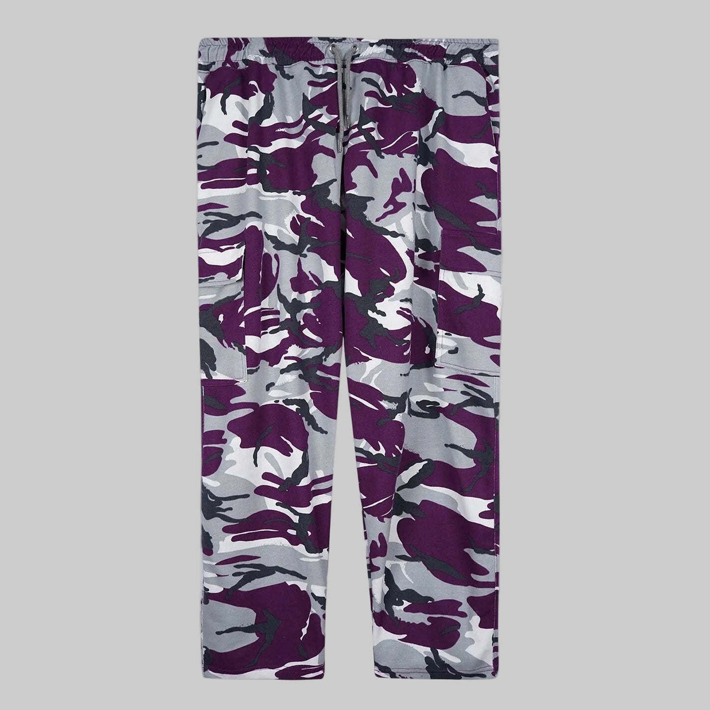 Camo Charge plus-size terry cargo pants worn by a Pakistani male model in a side pose, featuring a purple, grey, white, and black camouflage print with elastic waistband and side cargo pockets.