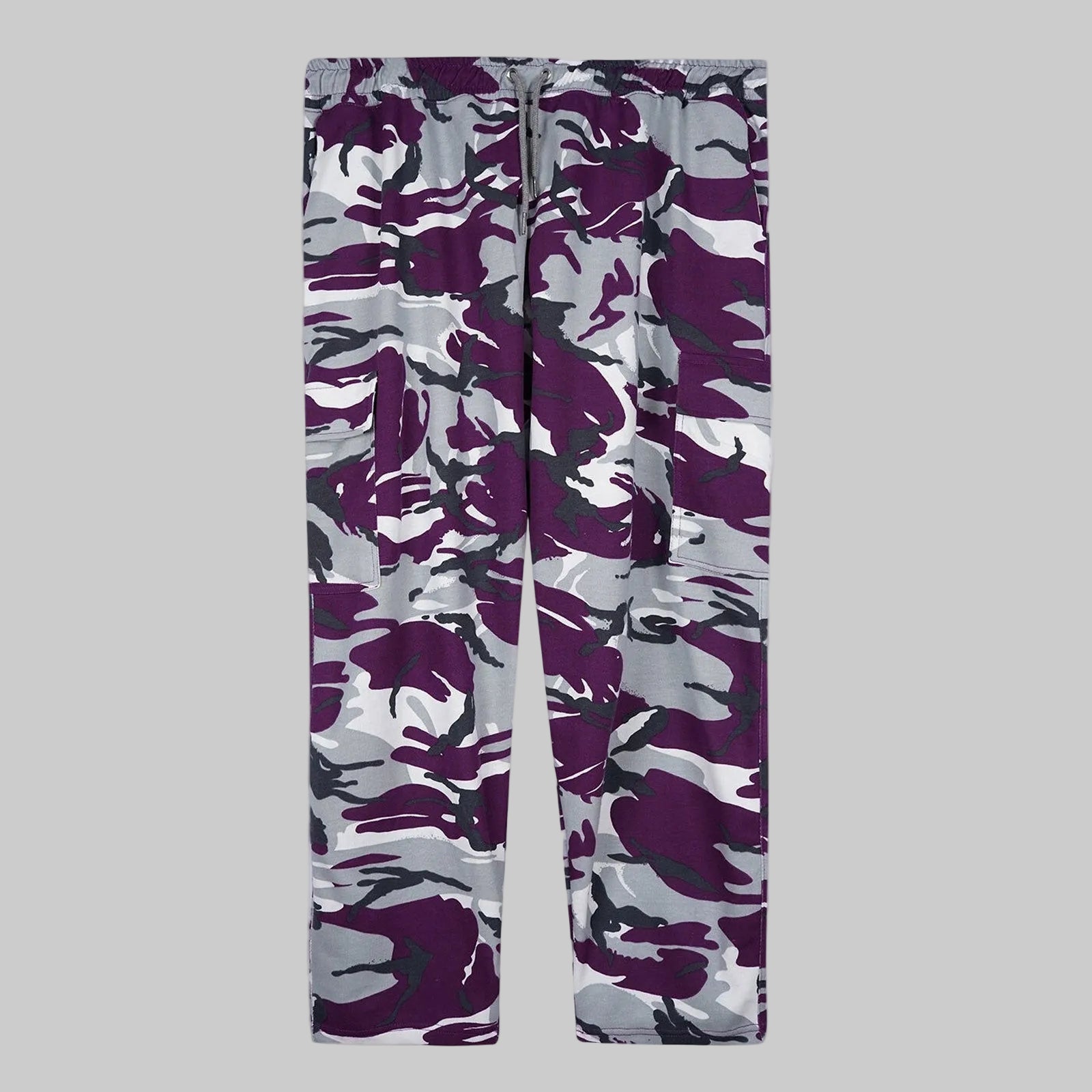 Camo Charge plus-size terry cargo pants worn by a Pakistani male model in a side pose, featuring a purple, grey, white, and black camouflage print with elastic waistband and side cargo pockets.