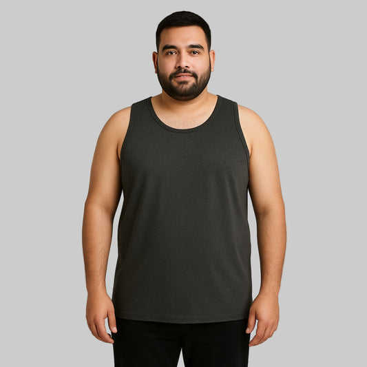 Plus-size Pakistani male model wearing charcoal sleeveless tank top on a clean studio background, relaxed fit.
