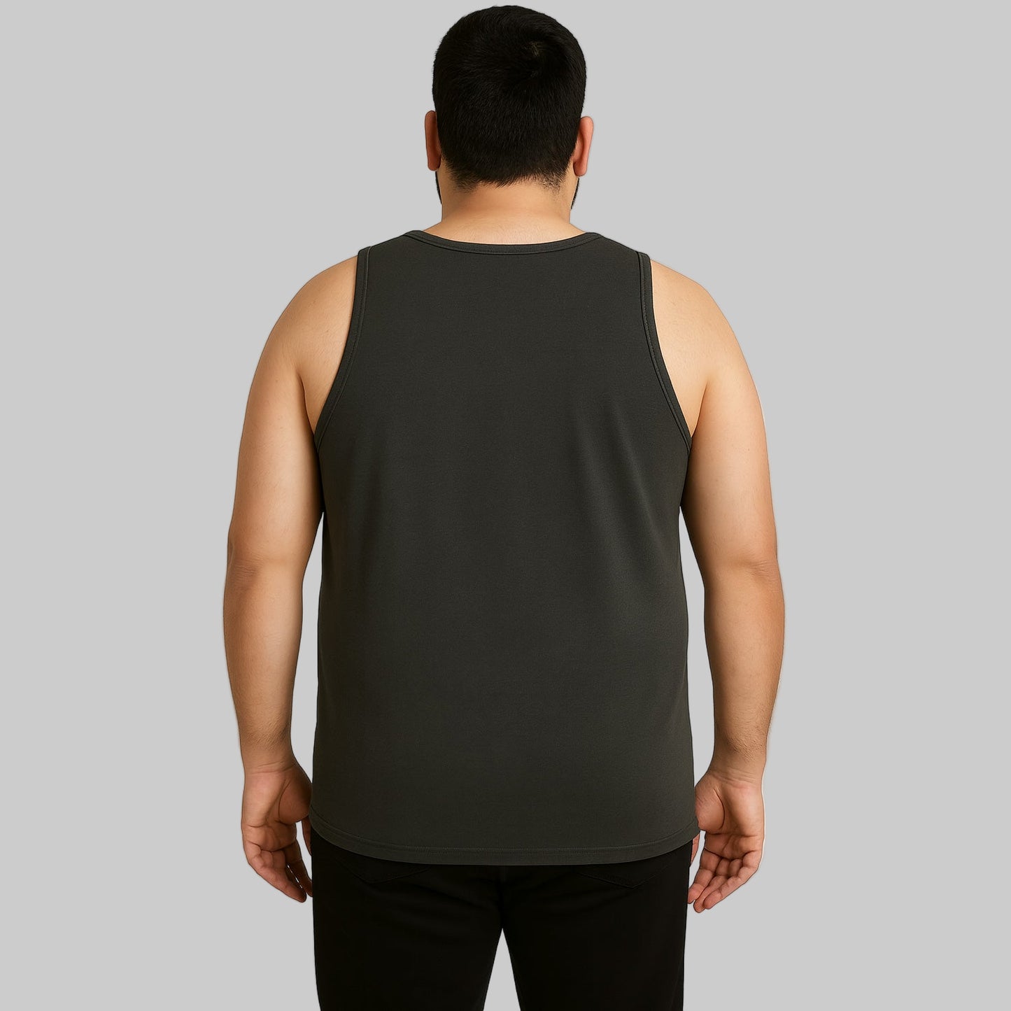 Plus-size Pakistani male model wearing charcoal sleeveless tank top on a clean studio background, relaxed fit.