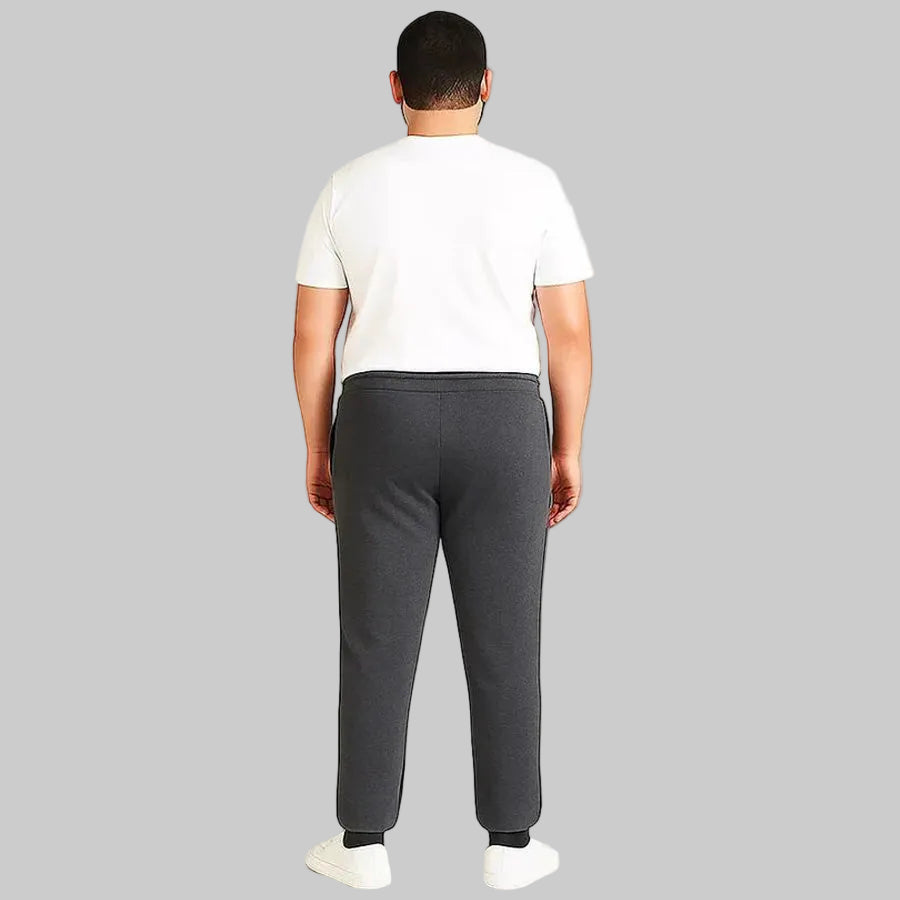 Pakistani plus size male model wearing charcoal side-striped trouser with elastic waistband and relaxed fit on white background