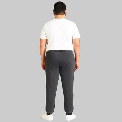 Pakistani plus size male model wearing charcoal side-striped trouser with elastic waistband and relaxed fit on white background