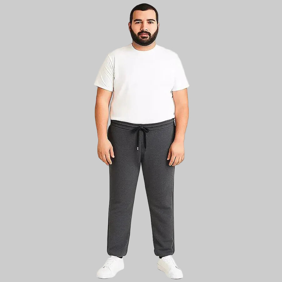 Pakistani plus size male model wearing charcoal side-striped trouser with elastic waistband and relaxed fit on white background