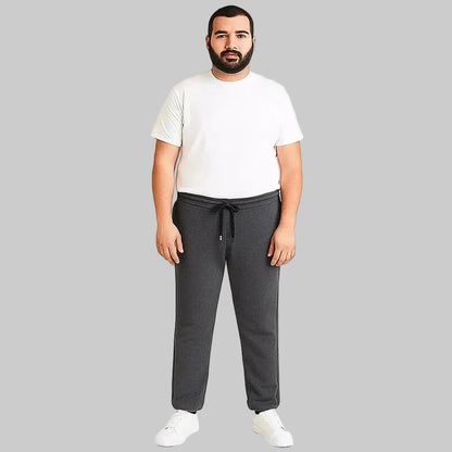 Pakistani plus size male model wearing charcoal side-striped trouser with elastic waistband and relaxed fit on white background