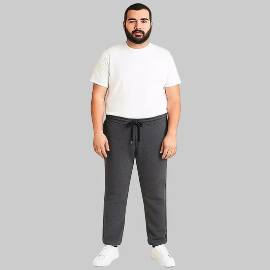 Pakistani plus size male model wearing charcoal side-striped trouser with elastic waistband and relaxed fit on white background