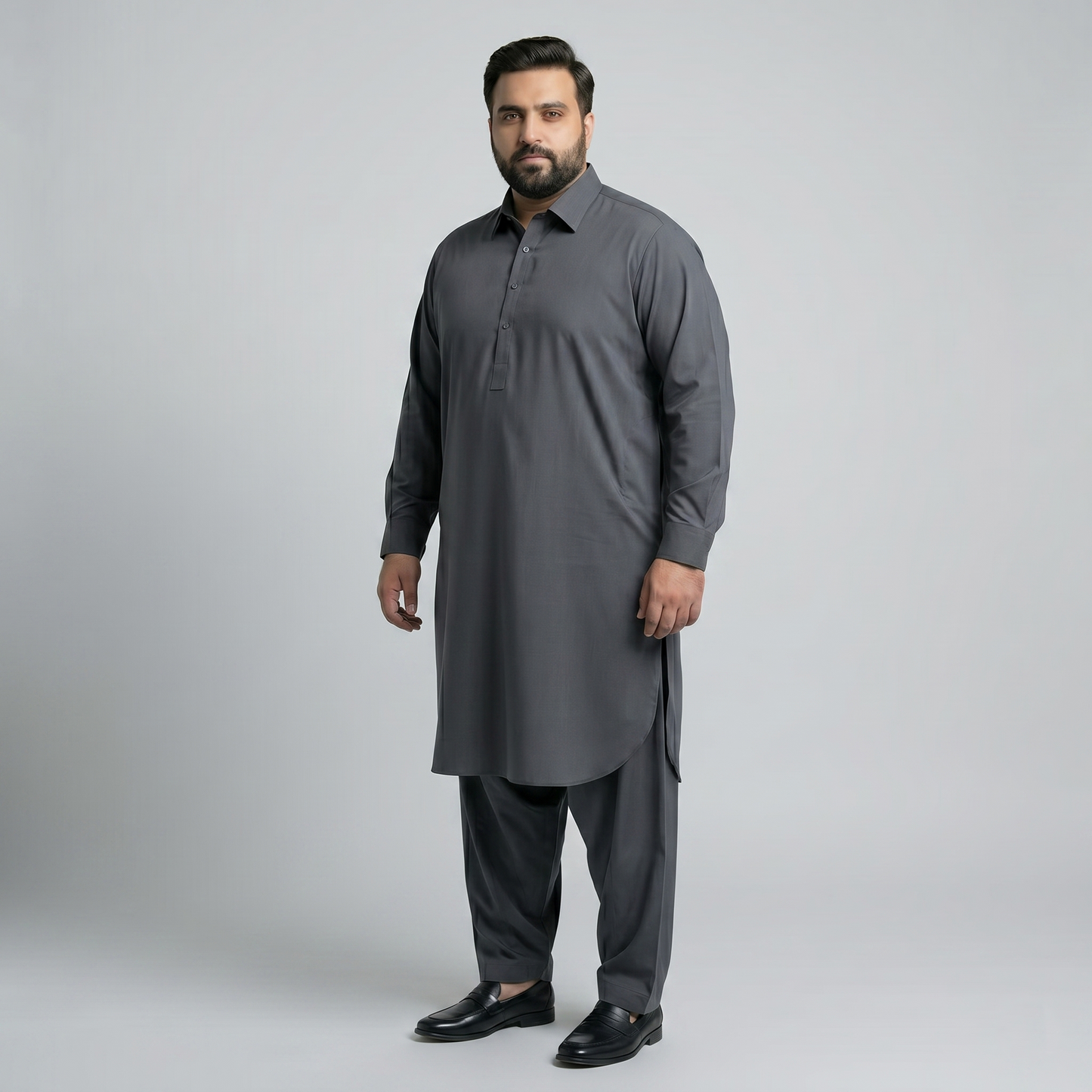 Man wearing a gray traditional outfit on a light gray background