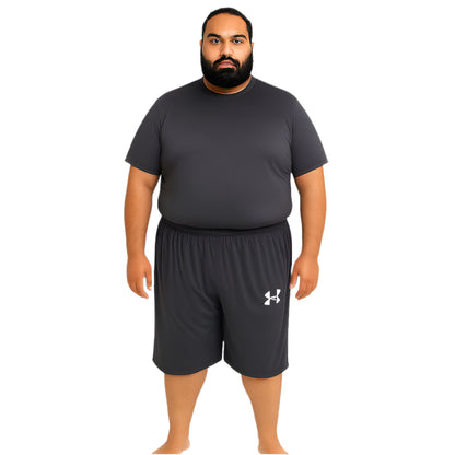 Plus-size Pakistani male model wearing charcoal three quarter Dry-Fit active shorts – front and back view, studio background