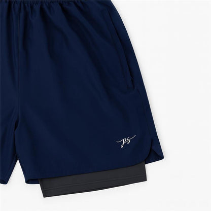 Plus-size male model wearing navy blue hybrid double-layer performance shorts with white t-shirt and sneakers