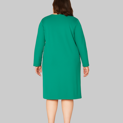Plus size woman wearing a Cool Emerald Comfort Long Sleeve Sleepshirt in emerald green with long sleeves, knee-length cut, and printed graphic.