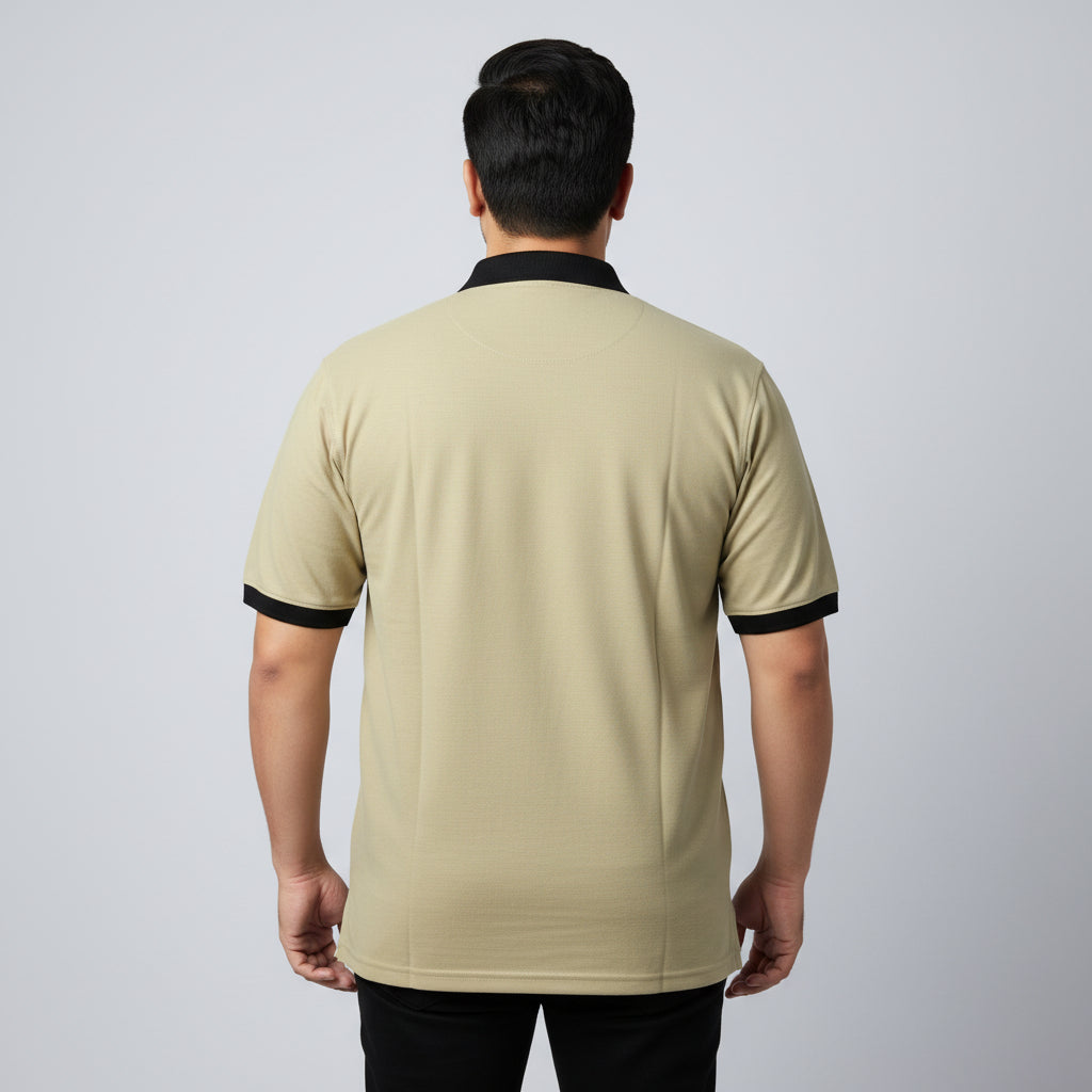 Alt Text: Men's classic beige short-sleeve polo shirt featuring a black contrast collar and ribbed sleeve trims, laid flat on a white surface.