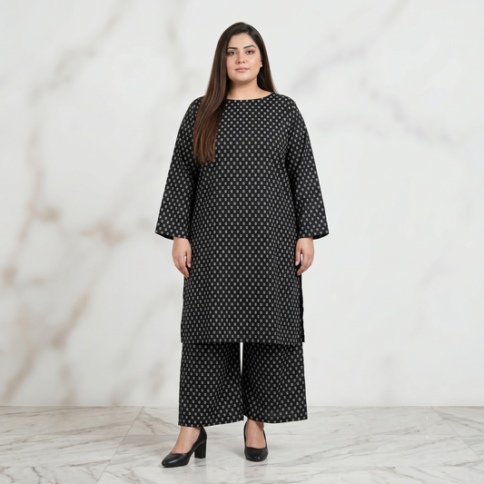 Woman wearing a black patterned outfit against a white background