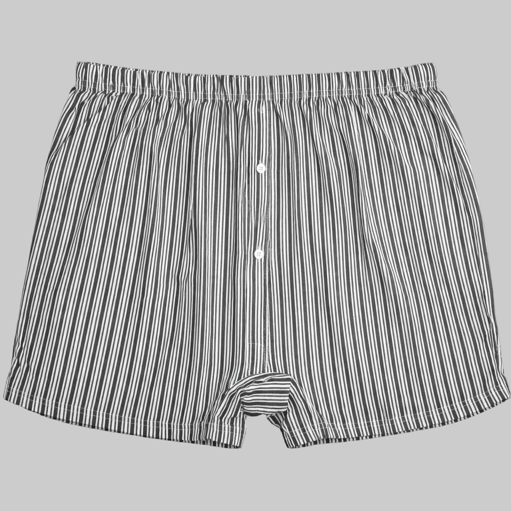 Black and white vertical stripe cotton boxer with elastic waistband and button fly laid flat on a white background