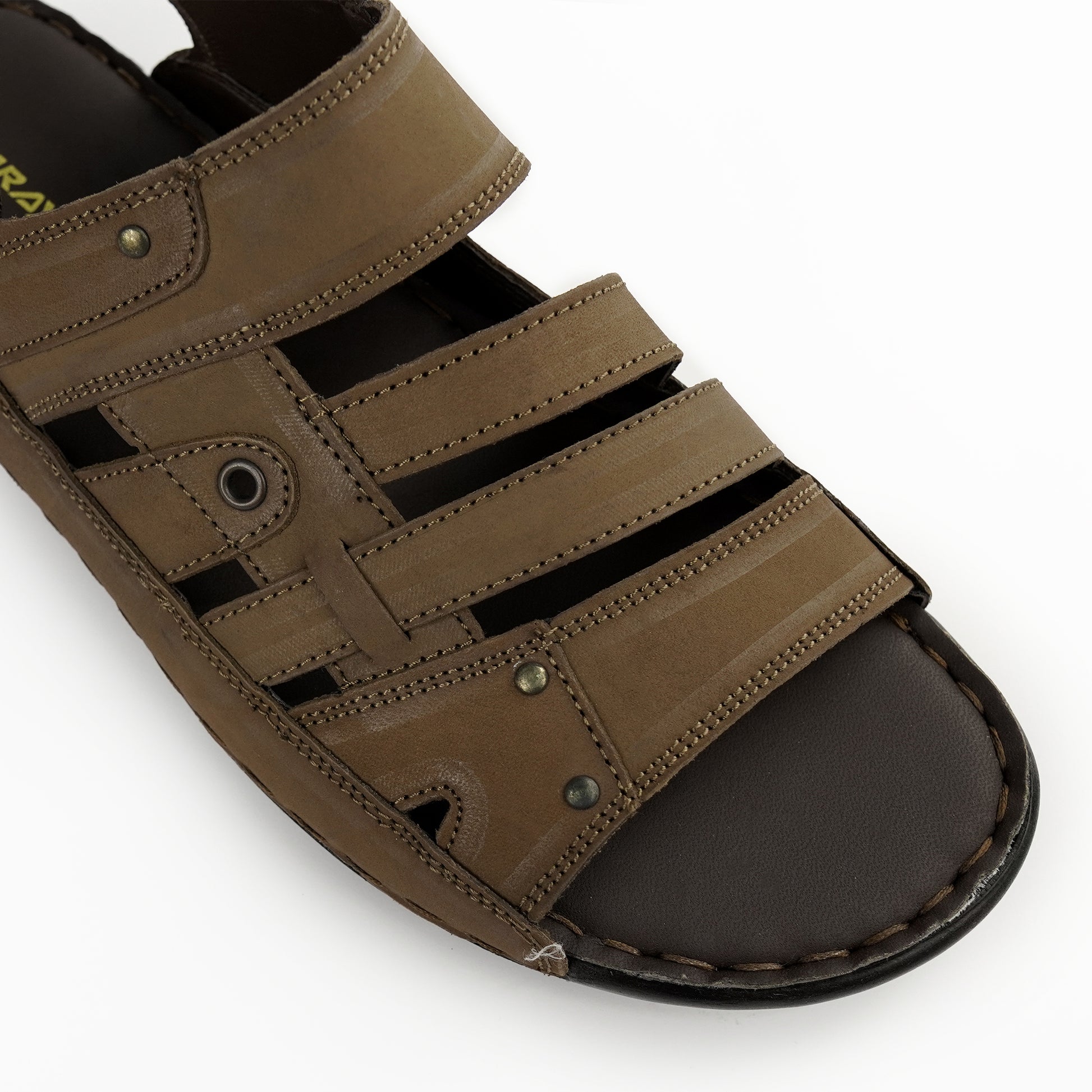 Close-up of stitching and rivet details on brown leather sandal – PlusSize.pk