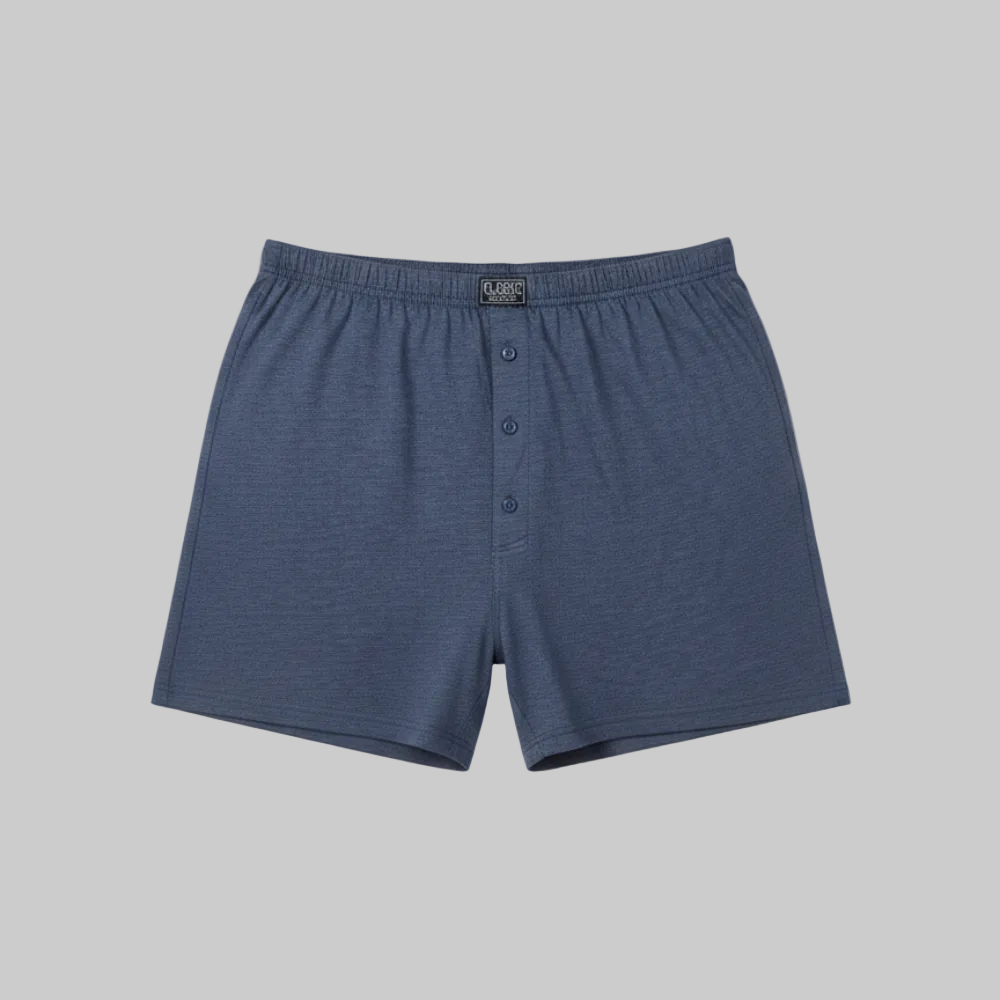 Classic navy blue cotton boxer with elastic waistband and button fly, laid flat showing a simple and comfortable everyday design