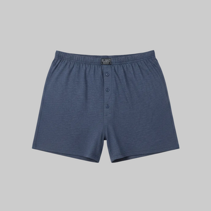 Classic navy blue cotton boxer with elastic waistband and button fly, laid flat showing a simple and comfortable everyday design
